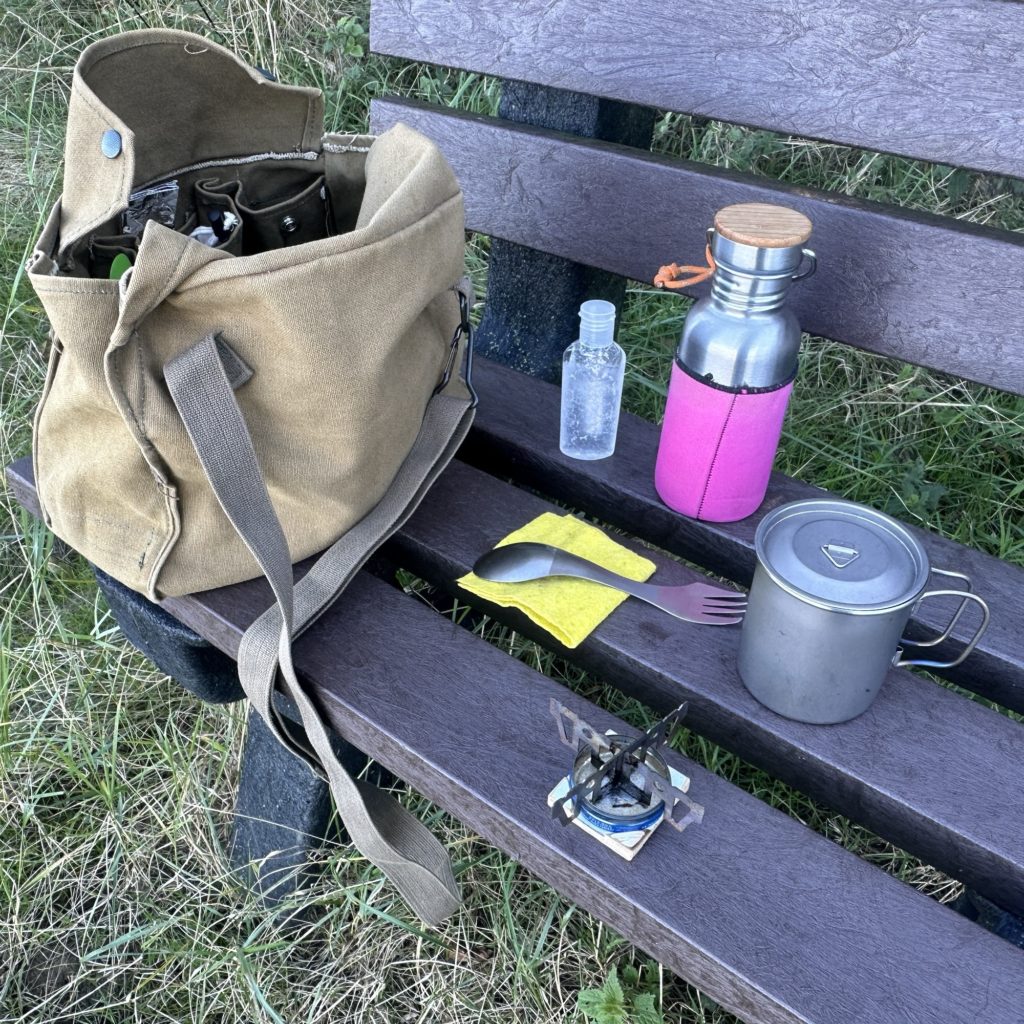 Homemade alcohol gel stove,​ titanium spork, mug and lid, stainless steel bottle and Finnish Army haversack